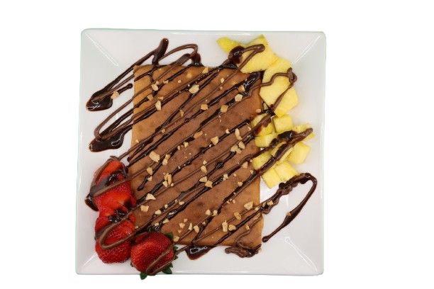 Crepe topped with pineapple, strawberries, peanut pieces, and chocolate drizzle