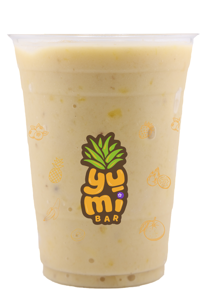 Tropical fruit smoothie with banana, pineapple, and mango in a cup